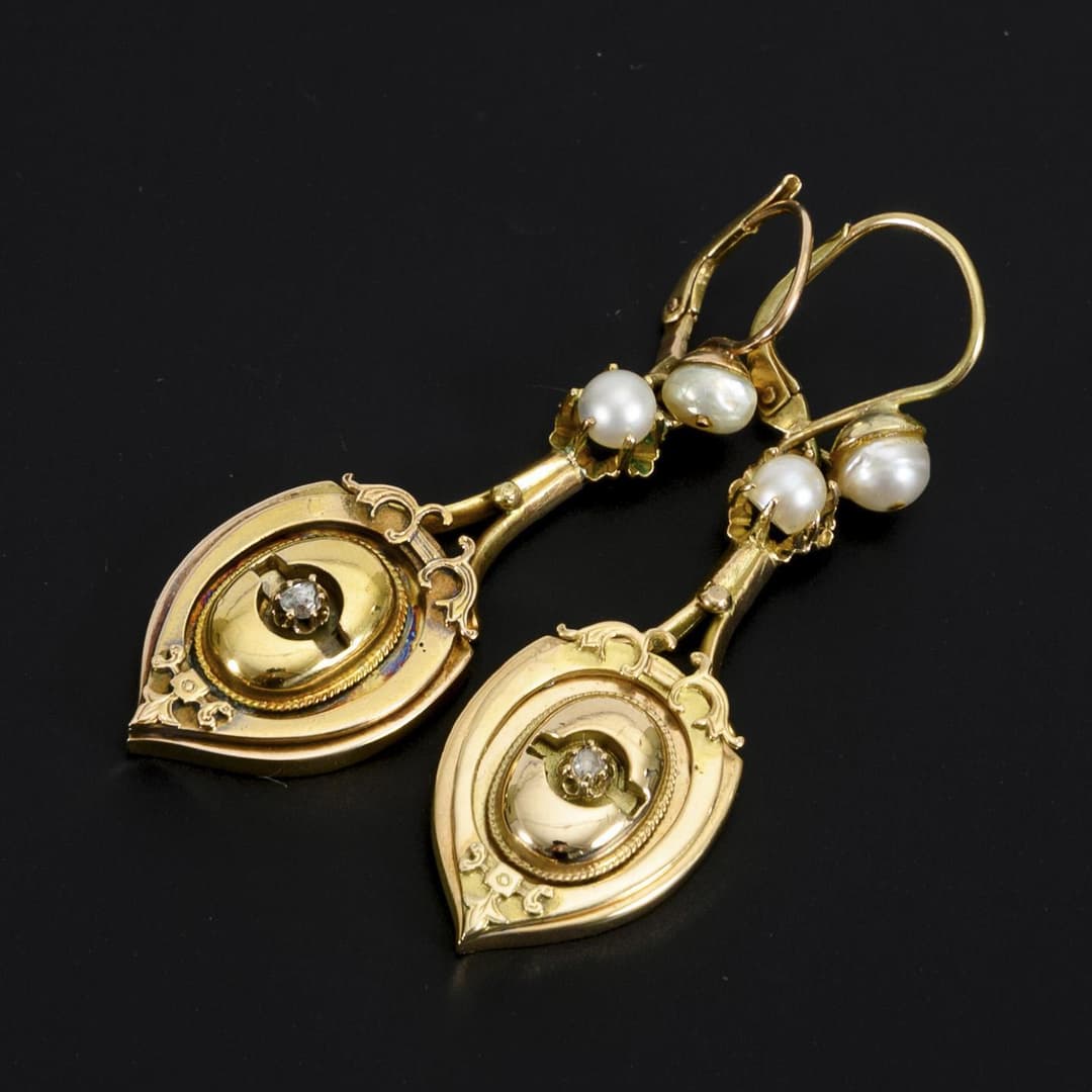 Earrings with historical elements and pearls.
