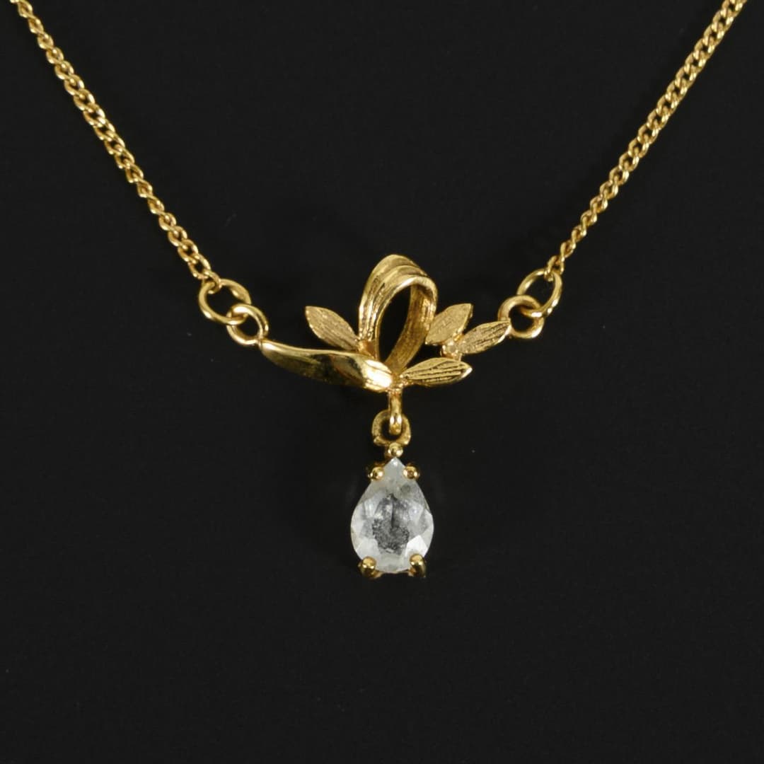 Delicate necklace with blue colored stone, probably blue topaz.